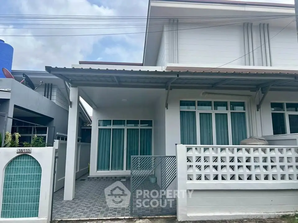 Charming modern house exterior with covered patio and stylish facade, perfect for family living.