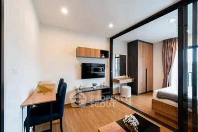 Modern apartment interior with stylish living room and bedroom, featuring wood accents and sleek design.