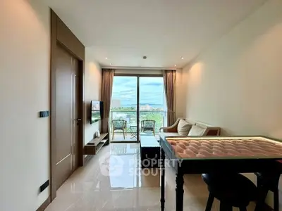 Modern living room with balcony and scenic view, featuring elegant furniture and natural light.