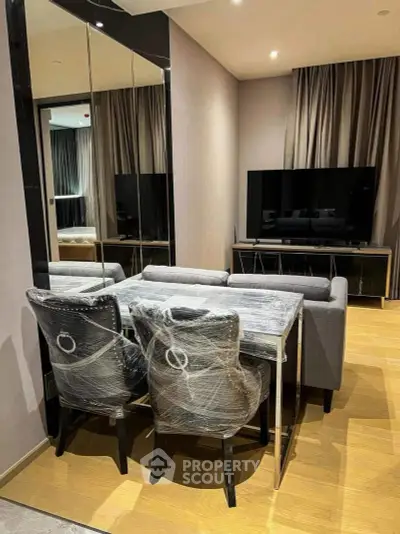 Modern living room with sleek furniture and large TV, perfect for relaxation and entertainment.