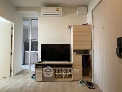 Modern living room with TV and air conditioning in cozy apartment