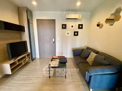 Modern living room with stylish decor and comfortable seating in a cozy apartment.