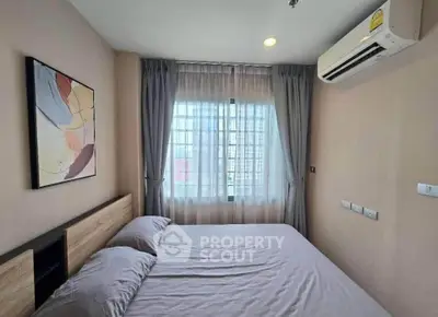Cozy bedroom with modern decor and air conditioning, featuring a large window with curtains.