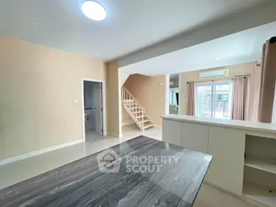 Spacious modern living room with open layout and elegant staircase