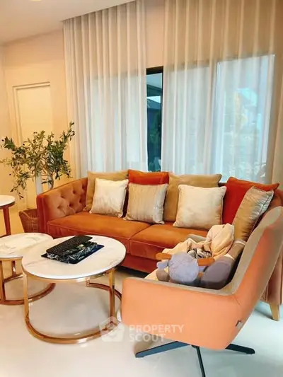 Stylish living room with plush orange sofa and elegant decor