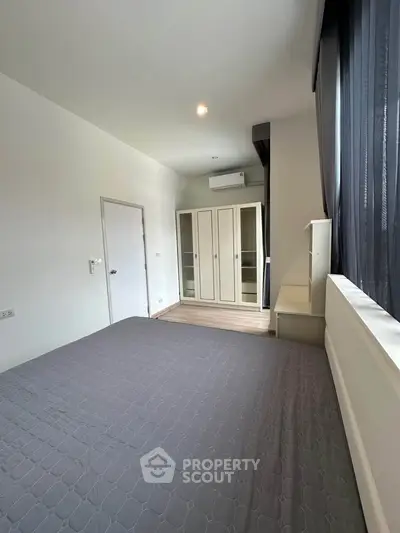 Spacious bedroom with modern wardrobe and natural light