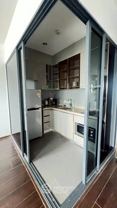 Modern kitchen with sleek appliances and open layout in a stylish apartment.