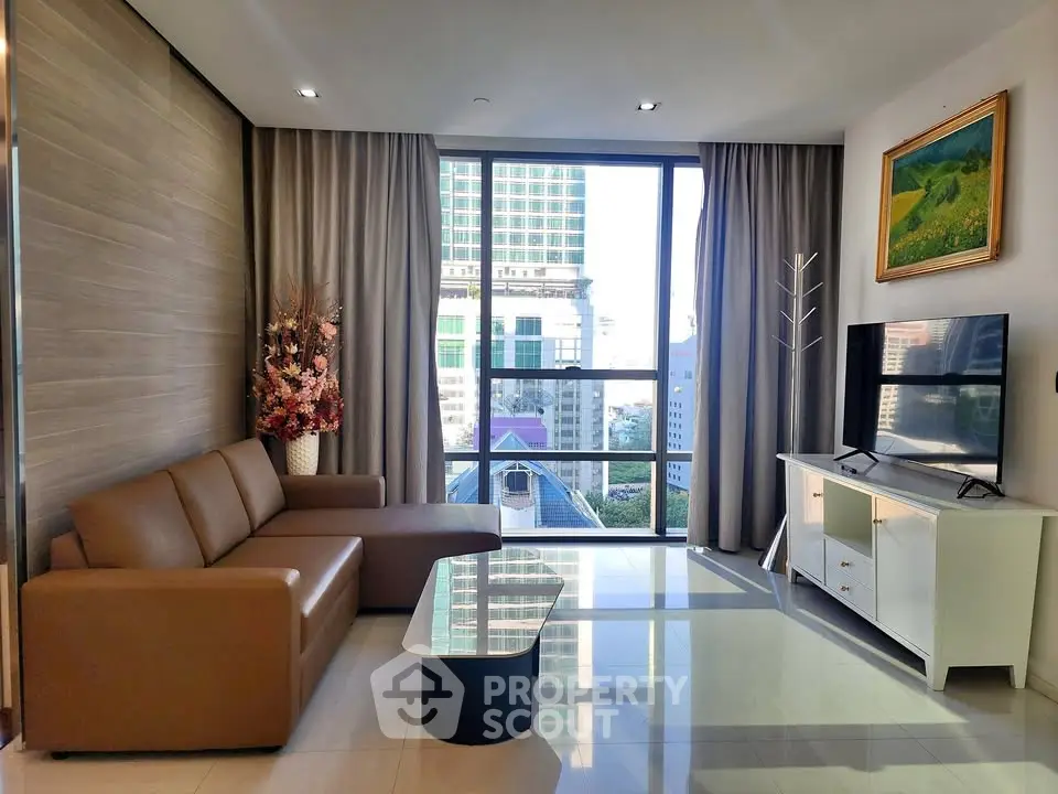 Modern living room with city view, stylish furniture, and large windows in a high-rise apartment.