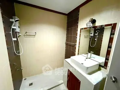 Modern bathroom with stylish sink and shower area in contemporary home.