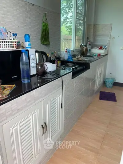 Spacious kitchen with modern appliances and ample counter space