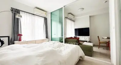 Modern bedroom with sliding glass doors and cozy living area