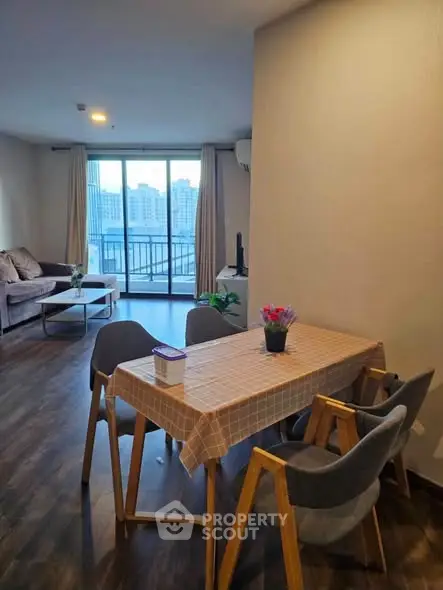 Spacious living room with dining area and balcony view in modern apartment