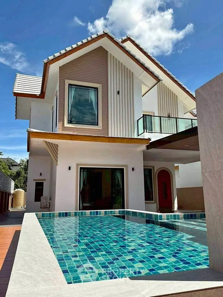 Stunning modern house with private pool and elegant balcony under clear blue sky.
