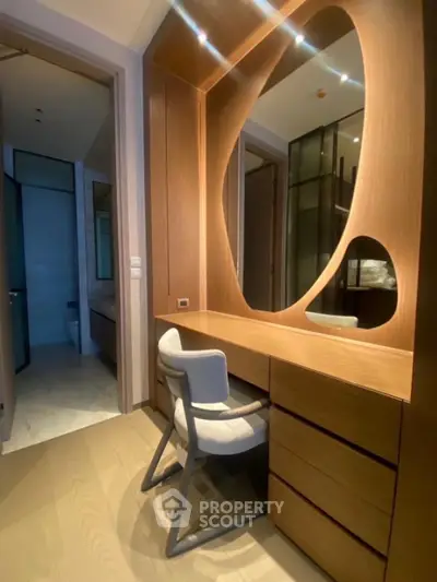 Elegant modern study area with wooden desk and stylish chair in a luxurious home.