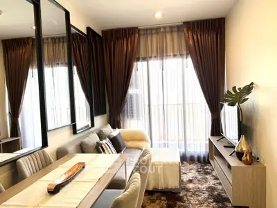 Elegant living room with modern decor, plush seating, and large windows for natural light.