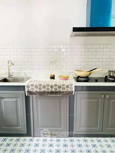 Charming kitchen with modern appliances and stylish tile flooring