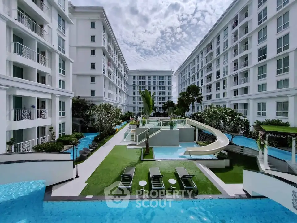 Luxurious apartment complex with stunning pool and lush garden view