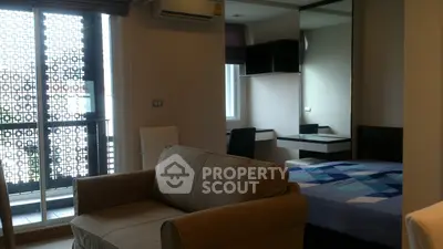 Modern studio apartment with cozy living area and stylish bedroom