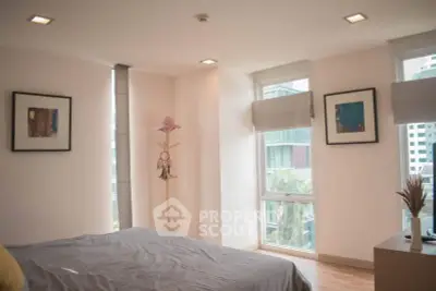 Bright and modern bedroom with large windows and stylish decor in urban apartment