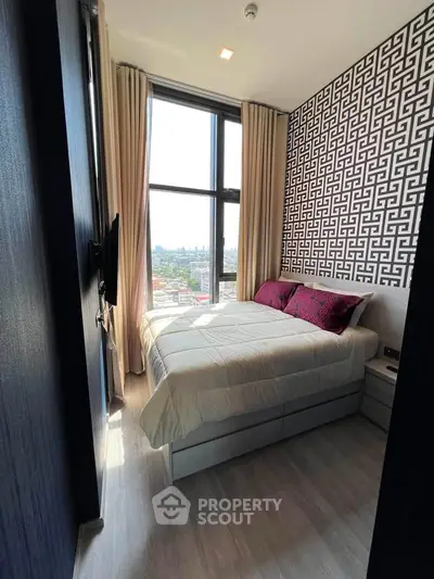 Stylish bedroom with large window and modern decor in high-rise apartment