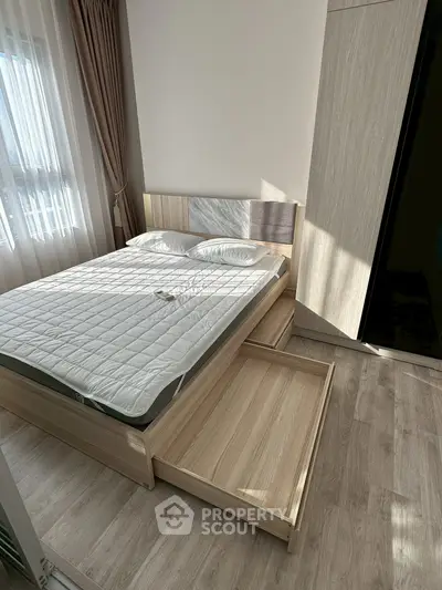 Modern bedroom with sleek wooden flooring and stylish bed with storage drawers