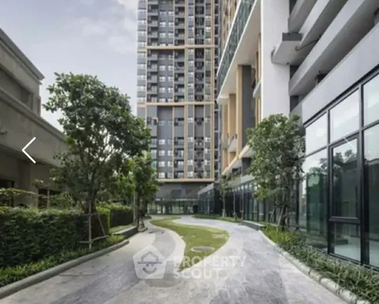 Modern apartment building with landscaped garden and pathway
