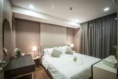 Luxurious bedroom with elegant decor and ambient lighting in modern apartment.