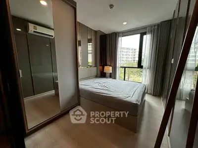 Modern bedroom with large windows and sleek design in urban apartment