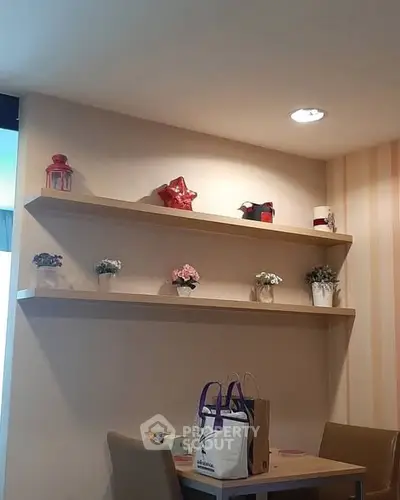 Cozy dining nook with decorative shelves and modern lighting, perfect for intimate meals.
