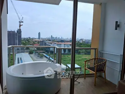 Luxurious balcony with bathtub and stunning city view, perfect for relaxation and enjoying the skyline.