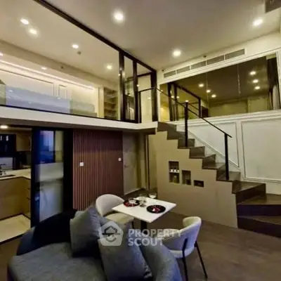 Modern duplex living room with stylish decor and open kitchen layout