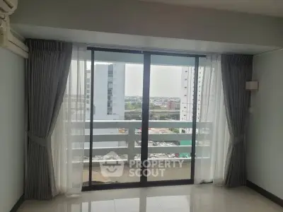 Spacious apartment with large windows offering stunning city views and abundant natural light.
