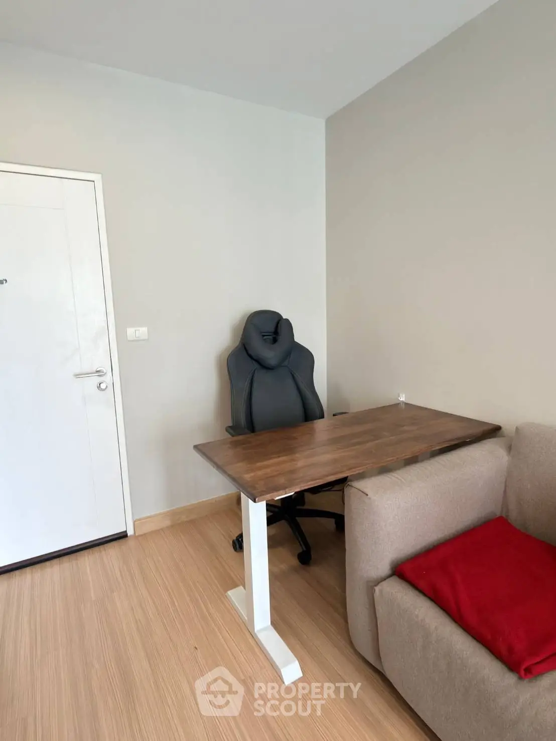 Modern study room with ergonomic chair and wooden desk in cozy apartment
