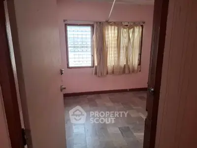 Empty room with tiled floor and curtained window, ready for customization.