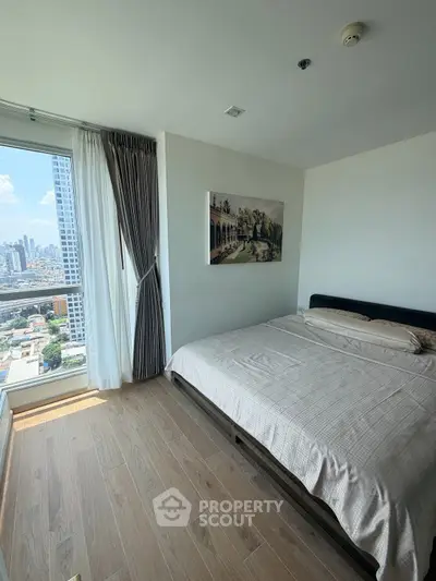 Spacious bedroom with city view in modern high-rise apartment