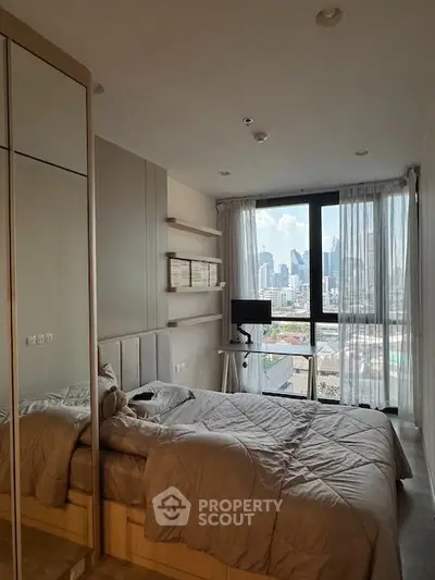 Modern bedroom with city view, featuring cozy bed and stylish decor in high-rise apartment.