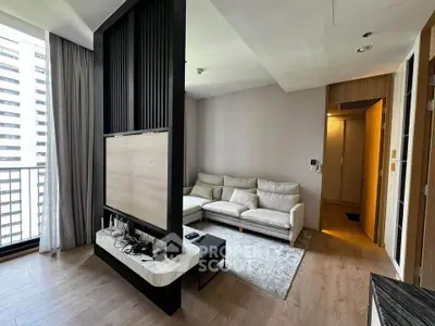 Modern living room with sleek partition and cozy seating area in high-rise apartment.