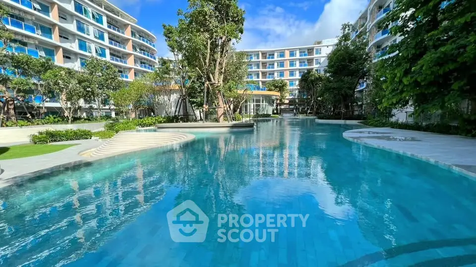 Luxurious residential complex with stunning pool and lush greenery