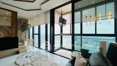 Luxurious high-rise living room with panoramic city views and modern decor