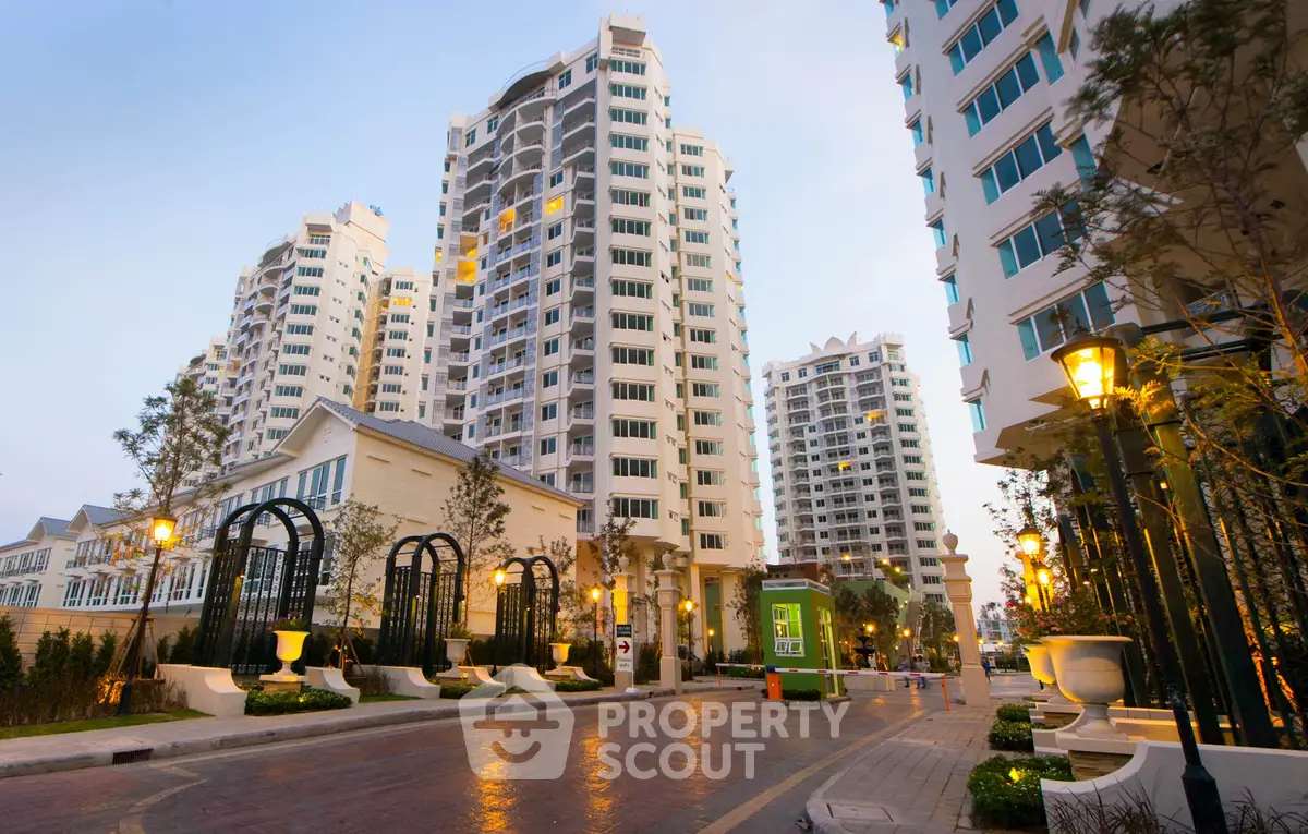 Luxurious high-rise residential buildings with elegant entrance and street lighting.