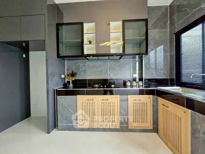 Modern kitchen with sleek cabinetry and gas stove in stylish apartment