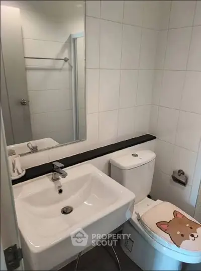 Modern bathroom with white tiles and stylish sink