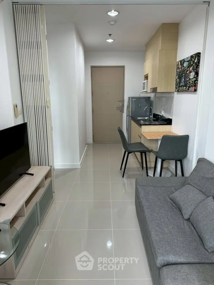 Modern apartment interior with sleek kitchen and cozy living area, perfect for urban living.