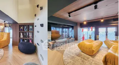 Luxurious living room with modern decor and unique seating, featuring floor-to-ceiling windows and stylish lighting.