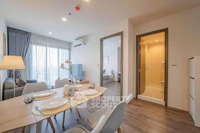 Modern open-plan living and dining area with elegant decor and natural light