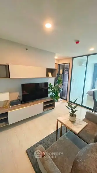Modern living room with stylish decor and natural light in a contemporary apartment.