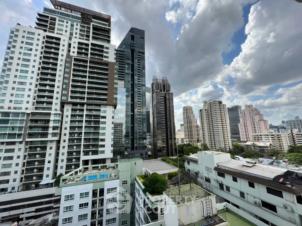 Stunning cityscape view of modern high-rise buildings under a dramatic cloudy sky.