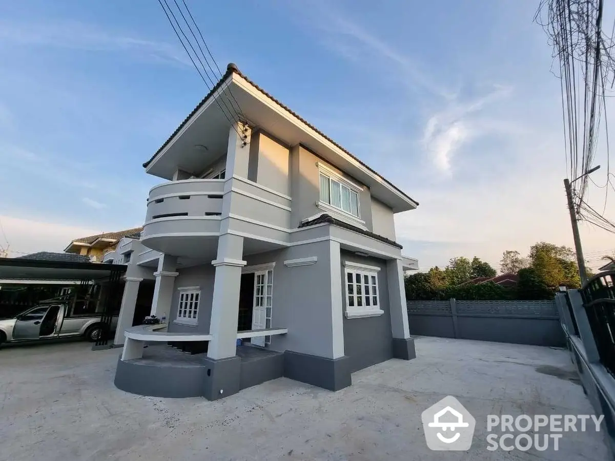 Spacious corner unit house with large windows and a modern facade, set against a clear sky at dusk, offering a serene suburban living experience.