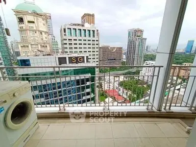 Stunning city view from high-rise balcony with washing machine, perfect urban living.