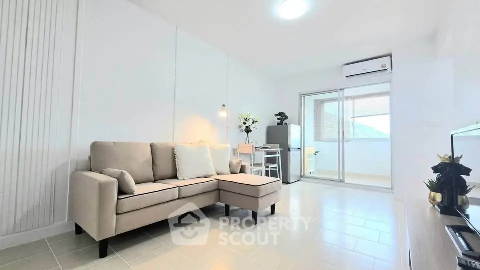 Bright modern living room with beige sofa and balcony view